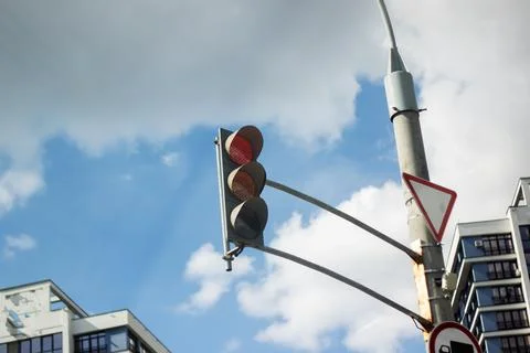 A bright red traffic light is currently hanging from a tall pole Fotos de archivo