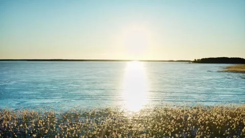 The bright reflection of the sun on the ice of a large body of water. Winter has Stock Footage 257777004
