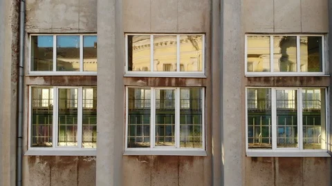 Bright reflections in large windows on monumental building concrete wall Video stock 89538897