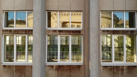 Bright reflections in large windows on monumental building concrete wall Video stock 89539079