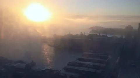 Bright rising sun disk in thick fog over  Sydney Harbour in 4k time lapse. Stock Footage 135307662