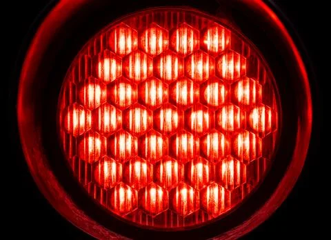 Bright round red light in the dark, object macro, detail, closeup, circle shape Stock Photos