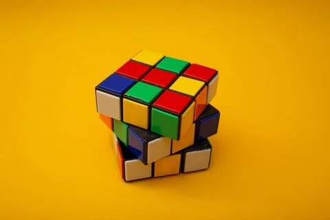 Bright rubik's cube on a yellow background Stock Photos