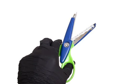 Bright scissors for cutting patterns in hand isolated on white background Foto stock