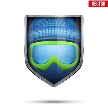 Bright shield in the winter cap and ski goggles inside. Vector. 스톡 일러스트