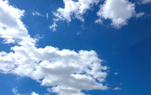 Bright Sky With Clouds Floating in the Afternoon Light Stock Photos