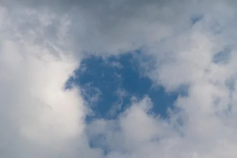 Bright sky contrasts shadows dramatically. Cloud breakthrough exposes vivid.. Foto stock