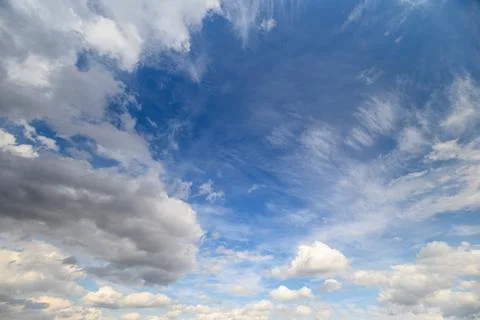 Bright sky with drifting clouds. Vast azure sky adorned with floating fluff.. Stock Photos