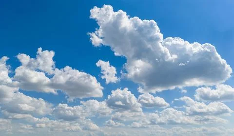Bright sky with fluffy clouds. Blue sky contains white clouds. Cloudy sky h.. Stock Photos