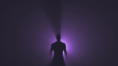 A bright source of purple light behind a man Foto stock