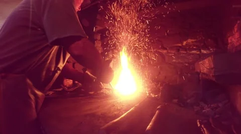 Bright sparkling high-temperature steaming small flame and blacksmith Stock Footage 46420231