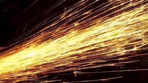 Bright sparks from the grinder shot close-up on a black background Stock Footage 115626540