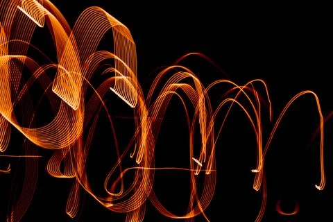 Bright spiral patterns from light strips on a black background Stock Photos