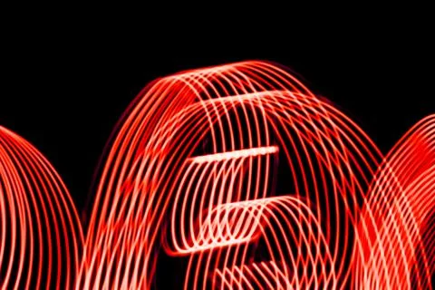 Bright spiral patterns from light strips on a black background Stock Photos