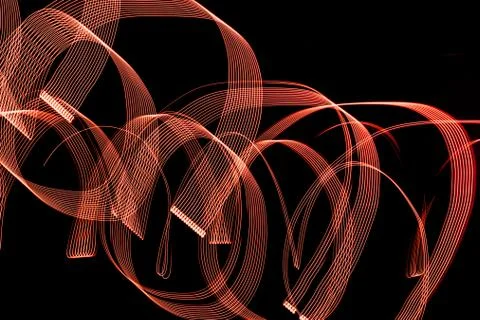 Bright spiral patterns from light strips on a black background Foto stock