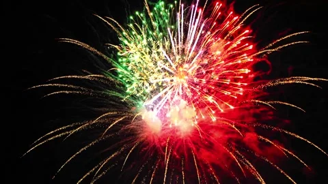 Bright splashes of fireworks flash on the black night sky green lilac gold... 库存影片 254905171