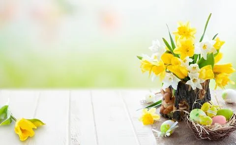 Bright spring Easter composition with yellow daffodils and tulips, pastel e.. Stock Photos