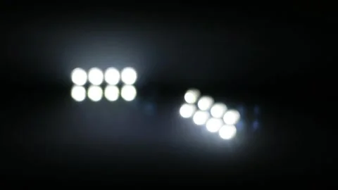 Bright stadium floodlights illuminating the dark night sky at a sports arena. Stock Footage 344963021