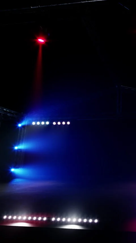 Bright stage lights create a colorful scene during a live performance event Stock Footage 337995893