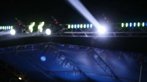 Bright stage lights shining in the dark night sky during a live concert event. Stock Footage 344961564