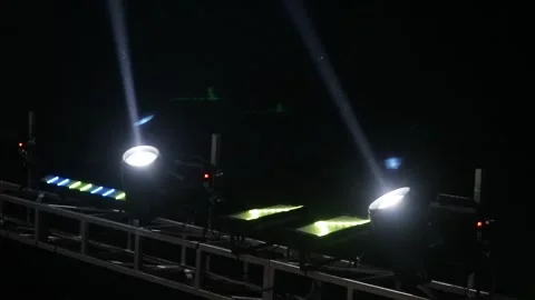 Bright stage lights shining in the dark night sky during a live concert event. Stock Footage 344961848