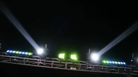 Bright stage lights shining in the dark night sky during a live concert event. Stock Footage 344962464