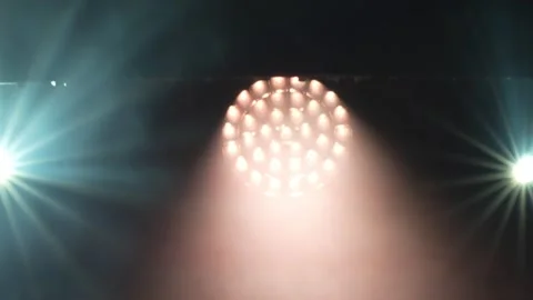 Bright stage spotlights casting multiple light beams through dense smoke. Stock Footage 344025880