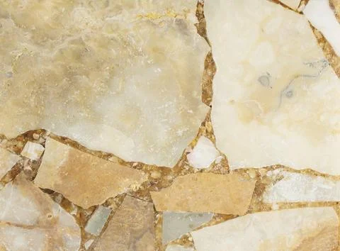 Bright stone blurred background from compressed marble fragments Stock Photos
