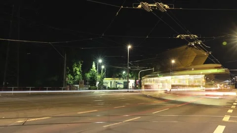 Bright streaks of light flow across a city street, created by passing Stock Footage 285152195