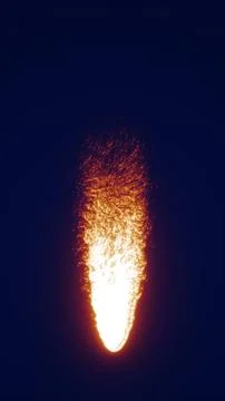 A bright stream of falling fire particles glowing against a dark background.. イラスト素材