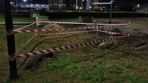 Bright street lanterns illuminating a night city street with construction. Stock Footage 343672475