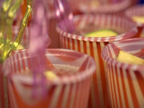 Bright striped glasses with lemonade and fruit at a close-up event Stock Footage 80963414