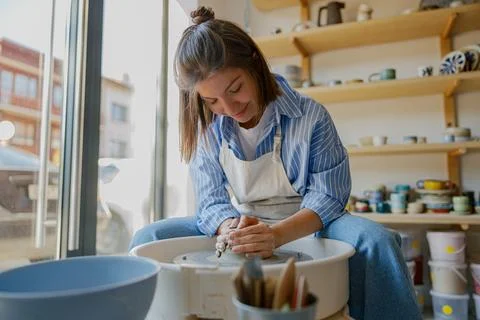 In a bright studio, artisans create pottery with colorful clay, blending Stock Photos