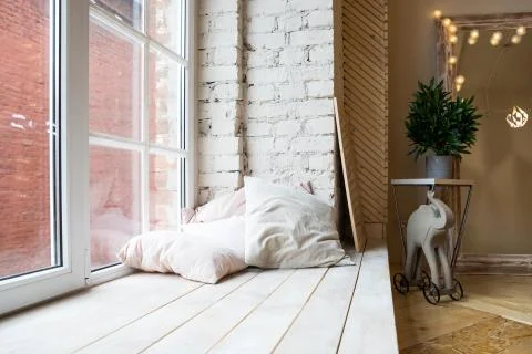 Bright studio interior with big window, high ceiling, wooden floor.Loft style Stock Photos