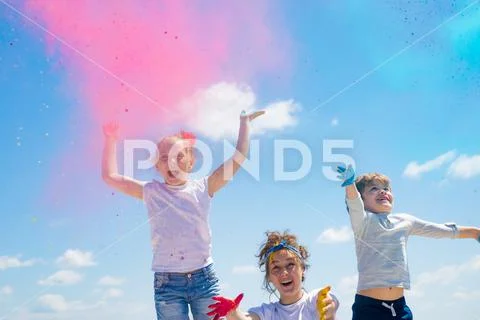 Bright summer colors. Adorable little kids with colored powder and color dust Stock Photos