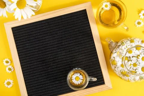 Bright Summer mock up. Empty blank black letter board and herbal chamomile te Stock Photos