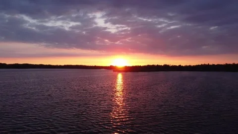 Bright Summer Sunset over the River. Flying with Drone. Stock Footage 155784876
