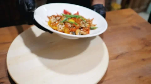 Bright summer vegetable salad with chicken yolk rotates on a white plate Stock Footage 202009676