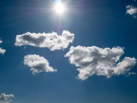 Bright Sun and Clouds in Blue Sky Stock Photos