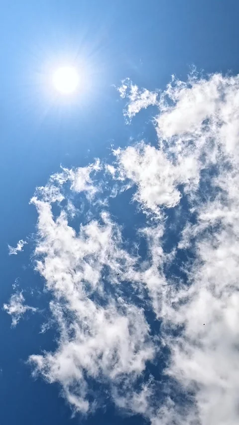 Bright sun and drifting clouds in clear summer sky Stock Footage 316570116
