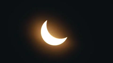 Bright sun around the solar eclipse as bright yellow rays bounce off both sides Stock Footage 270239638