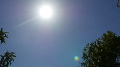 Bright sun on a blue sky background Stock Footage 96196552