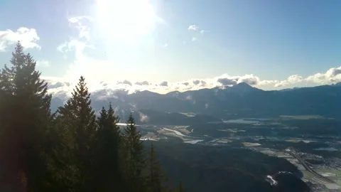 Bright sun in the blue sky, white clouds are visible from behind Stock Footage 256433889