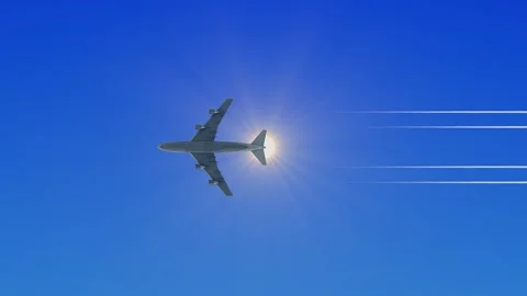 Bright sun in clear blue sky with aircraft silhouette on the edge Stock Footage 325037716