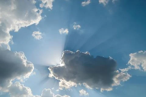 Bright sun on cloudy sky Stock Photos