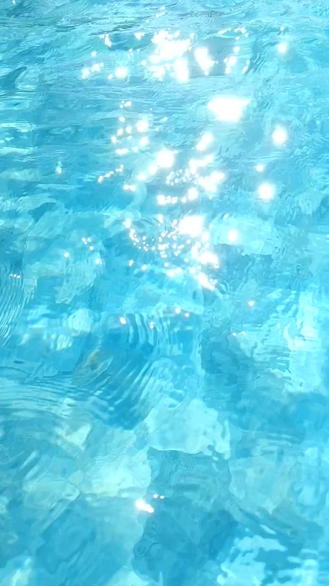 Bright sun glare on clear blue swimming pool water ripples background Stock-Footage 344453414