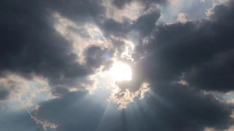 Bright sun light n sunlight ray shining on dark rain storm cloud in blue sky Stock Footage 330095590