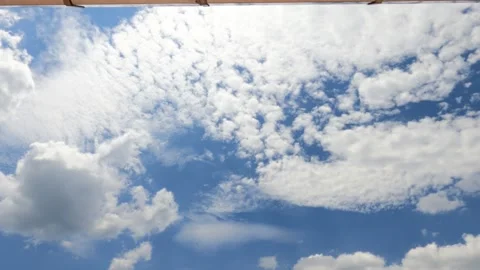 Bright sun light ray with cirrocumulus clouds under reflection roof Stock Footage 153458748