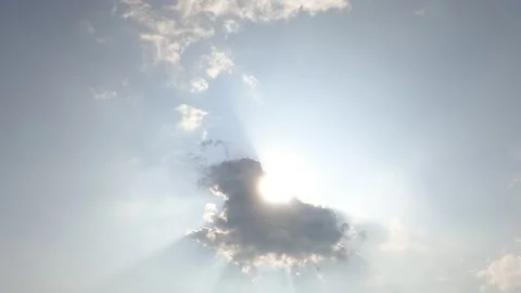 Bright sun light ray flare n bokeh sunbeam shining through dark clouds Video stock 153460766