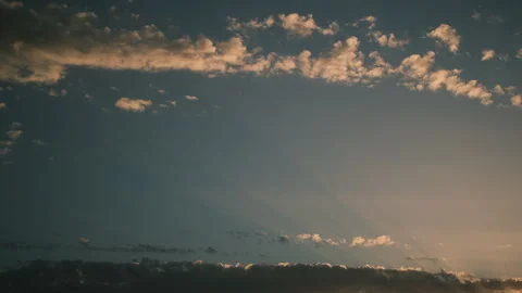 Bright sun light ray flare sunbeam shining through colorful dark clouds 스톡 동영상 250309857